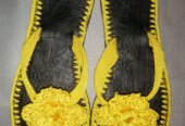 Men and women hand craft shoes