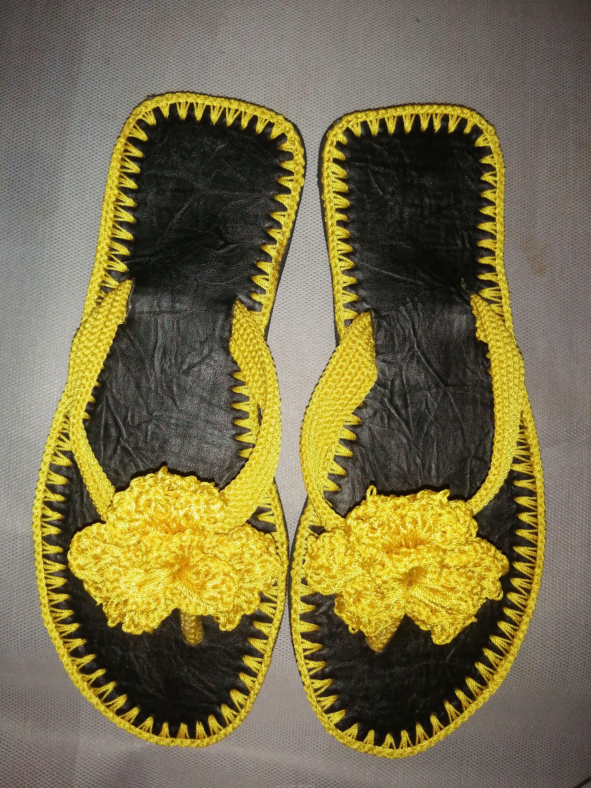 Men and women hand craft shoes