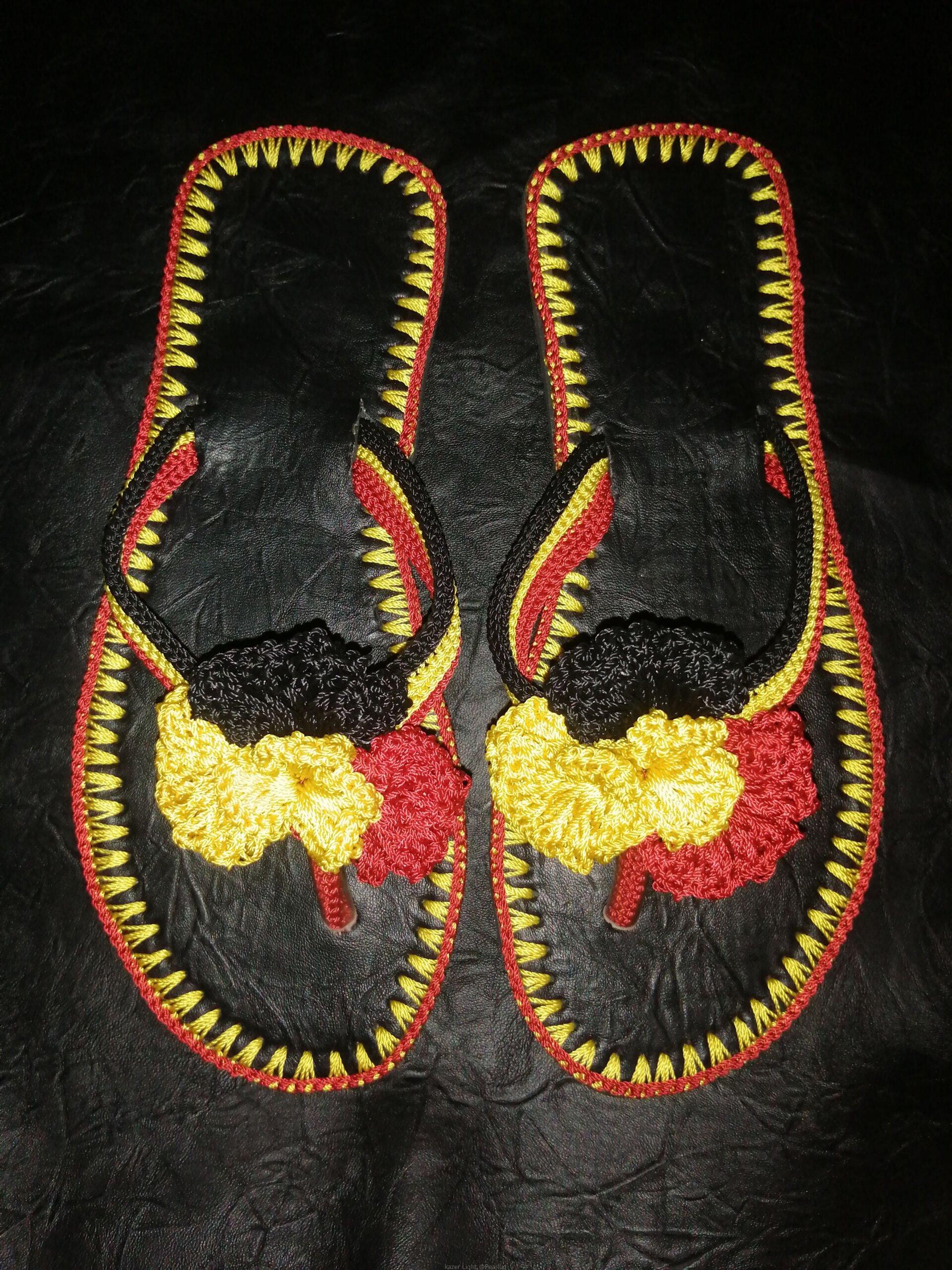 Men and women hand craft shoes